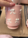 Pink Ceramic Cup with White Bow Design